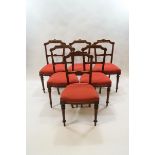 A set of six Victorian walnut dining chairs with aesthetic movement, inspired backs,