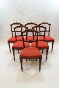 A set of six Victorian walnut dining chairs with aesthetic movement, inspired backs,