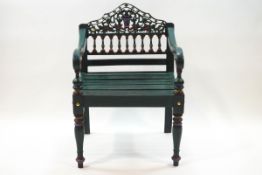 A painted pine garden chair with decorative pierced and carved spindle back,