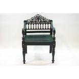 A painted pine garden chair with decorative pierced and carved spindle back,