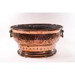 A Victorian oval copper planter with brass handles,