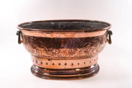 A Victorian oval copper planter with brass handles,