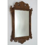 A George III style walnut fret framed wall mirror,