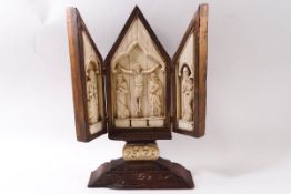 A 19th century Continental carved bone triptych, the central panel depicting Christ on the cross,