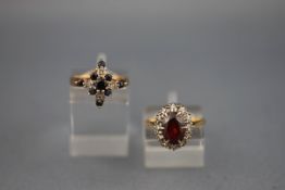 A stamped 18ct cluster ring set with garnets and diamonds together with a hallmarked 9ct gold ring