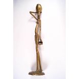 A polished bronze African tribal figure of a woman carrying water,