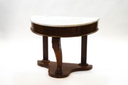 A Victorian mahogany demi-lune wash stand with marble top over a deep frieze and one shaped leg