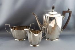 An early 20th century three piece silver coffee service, of fluted ovoid form,