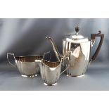 An early 20th century three piece silver coffee service, of fluted ovoid form,