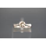 A hallmarked 18ct white gold solitaire ring set with a round brilliant cut diamond measuring