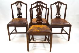 A set of four George III style mahogany chairs with leather drop in seats