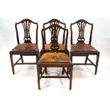 A set of four George III style mahogany chairs with leather drop in seats