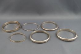 A selection of six hollow bangles, each stamped '925' or hallmarked sterling silver.