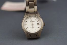 A Pulsar titanium lady's wristwatch. White baton dial with date feature.