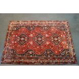 A 20th century Iranian Shiraz rug with central triple linked diamond motif surrounded by animal and