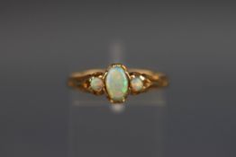 A yellow metal three stone opal ring. Test indicates 18ct. Gross weight: 2.