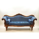 A Victorian mahogany show frame sofa with arched back, scroll arms and turned legs,