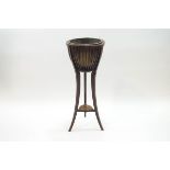 A Regency style mahogany jardiniere stand with brass liner, slatted surround and sable legs,