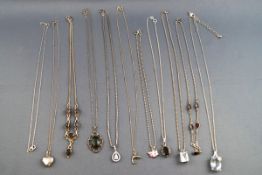 A collection of eleven silver necklaces and pendants to include one Pandora double hearts necklace.