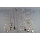 A collection of eleven silver necklaces and pendants to include one Pandora double hearts necklace.
