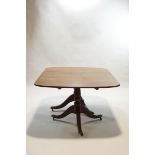 An early 19th century style mahogany dining table with twin pedestals,