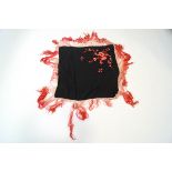 A Chinese embroidered fringed shawl with pink flowers on a black ground,