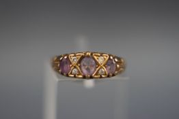 A 9 carat gold dress ring set with amethyst and diamonds.