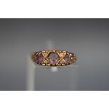 A 9 carat gold dress ring set with amethyst and diamonds.