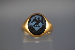An 18 carat signet ring set with seal of liver bird. Hallmarked 18ct, Birmingham. 'CG&S' 8.
