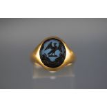 An 18 carat signet ring set with seal of liver bird. Hallmarked 18ct, Birmingham. 'CG&S' 8.