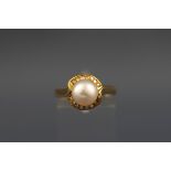 A yellow metal cluster ring set with a cultured pearl measuring 8.2mm.