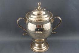 A silver two handled cup and cover, on flared foot,