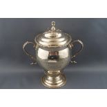 A silver two handled cup and cover, on flared foot,