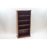 A mahogany standing bookcase with four fixed shelves on a plinth base, 125cm high x 66cm wide x 25.