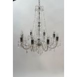 A glass and acrylic hanging eight branch chandelier with moulded glass drip pans and drops,