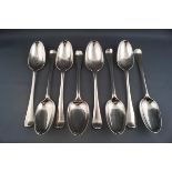 A composite set of eight George II and George III table spoons, each engraved with the family crest,
