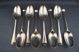 A composite set of eight George II and George III table spoons, each engraved with the family crest,