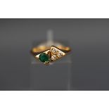 A yellow metal emerald and diamond dress ring, tests indicate 18ct gold. 3.