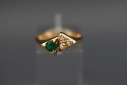 A yellow metal emerald and diamond dress ring, tests indicate 18ct gold. 3.