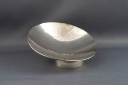 A silver bowl, of shallow circular form, with an off-set cylindrical foot, 11.