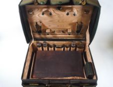 A green leather ladies dressing case with gilt initials 'V.H.