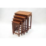 A nest of four Chinese hardwood tables, each with carved frieze and shaped stretchers, largest 65.