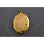A hallmarked 9 carat gold oval locket with floral engraved design and satin/polished finish.