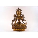 A 20th century Sino Tibetan gilt metal figure of the deity Tara,