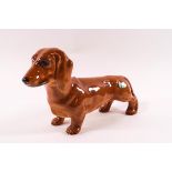 A Beswick model of a Dachshund, circular printed factory mark and paper label, 14cm high,