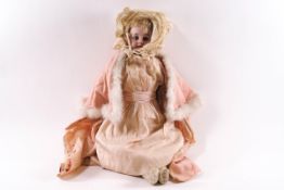 A Victorian porcelain doll, probably French, with bisque head and neck,