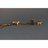 Five assorted 9 carat gold charms consisting of a Mouse, Cow, Tritan figure,