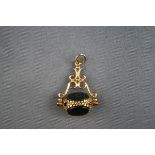 A hallmarked 9 carat gold triple swivel fob set with carnelian, onyx and bloodstone.