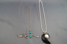 A selection of five miscellaneous pendants and necklaces to include one large shell pendant on