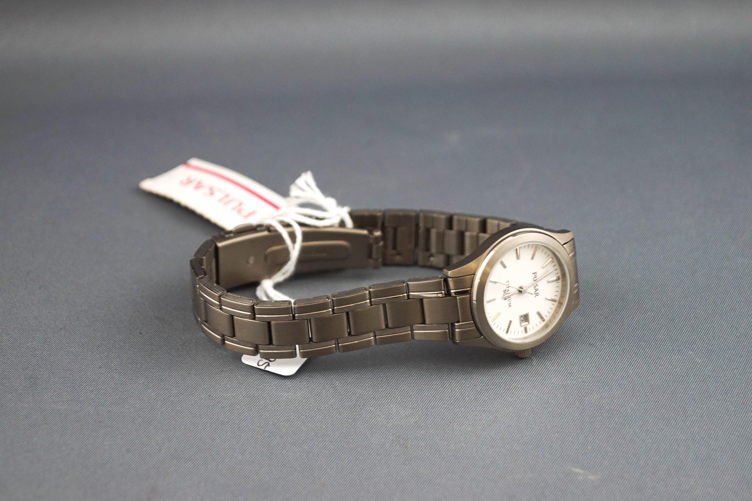 A Pulsar titanium lady's wristwatch. White baton dial with date feature. - Image 2 of 2